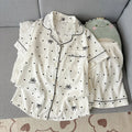 White pajama set with black details on a gray surface